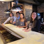 Montreal 2024 Summer Students making pizza at Bevo during a firm event
